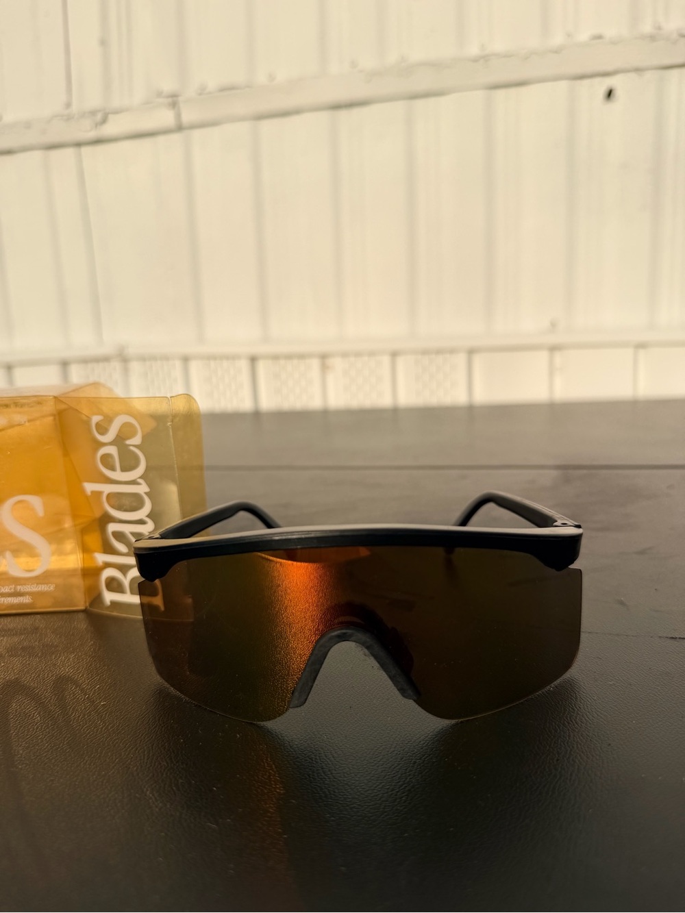 Oakley Black Frame Sunglasses with Amber-Red Mirrored Lens